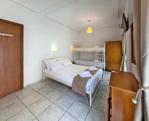 a bedroom with a bed and bunk beds in it at MELI Studios by SDR in Paralia Katerinis