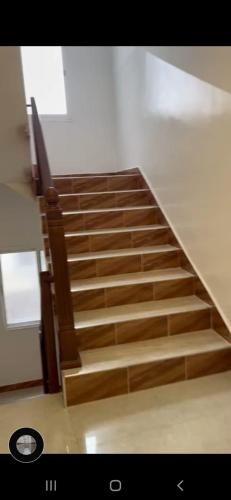 a staircase with wooden steps in a building at Résidence Martil Deluxe in Martil