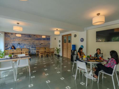 a group of women sitting at tables in a room at The Hosteller Goa, Old Goa in Old Goa