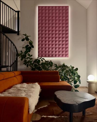 a living room with a couch and a plant at Mátramélye Vendégház in Parád