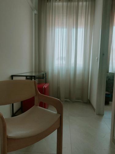 a living room with a chair and a table at Hotel San Domingo in Lido di Camaiore