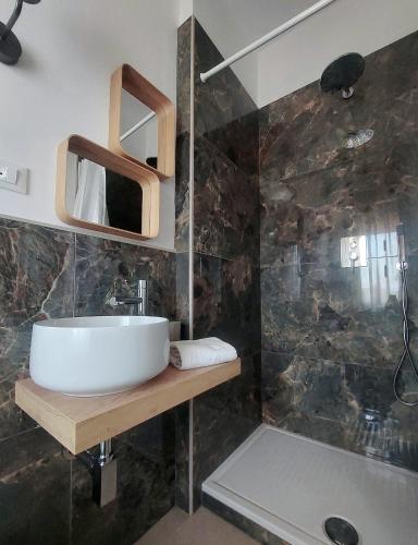 a bathroom with a sink and a shower at Hotel San Domingo in Lido di Camaiore