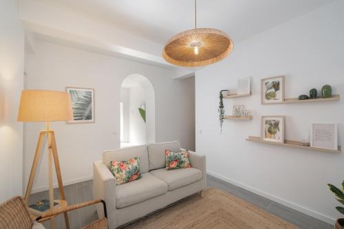 a living room with a couch and a lamp at Barlavento by An Island Apart in Porto Santo