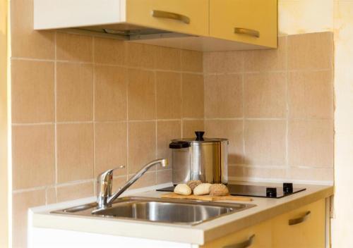 a kitchen sink with a pot on a stove at Hotel & Residence Venezia 2000 in Venice-Lido