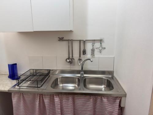 a stainless steel sink in a small kitchen at Casa Brezza Marina - Appartamento Brezza in Torre Lapillo