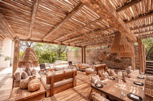 an outdoor living room with a wooden ceiling at Kapama Karula in Kapama Private Game Reserve