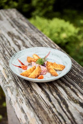 a plate of food on a wooden table at Hotel Luitpold am See in Prien am Chiemsee