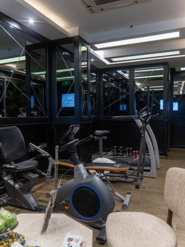 a gym with bikes and exercise equipment on a table at Hyksos Hotel in Erbil