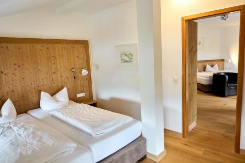 a hotel room with a bed and a bedroom at Hotel Luitpold am See in Prien am Chiemsee