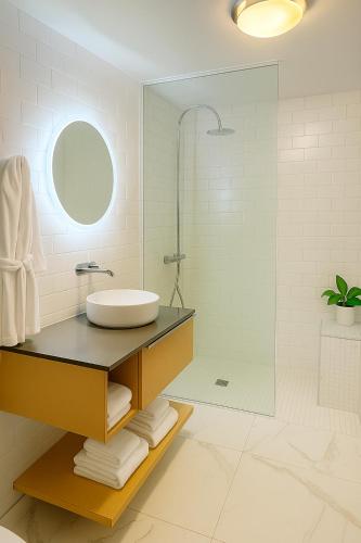 a bathroom with a sink and a shower at Auberge Saint-Pierre in Quebec City