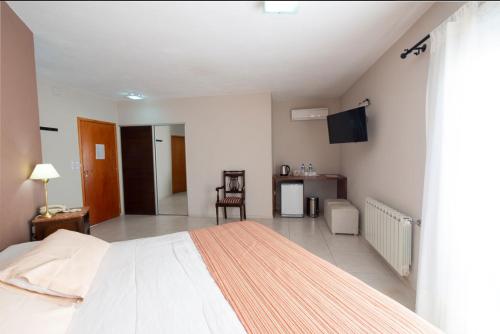 a bedroom with a bed and a tv in it at La Cautiva in Los Reartes