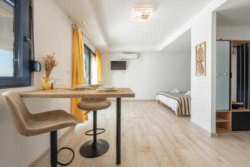 a room with a table and a chair and a bed at Unique Villa V with large pool in Benkovac