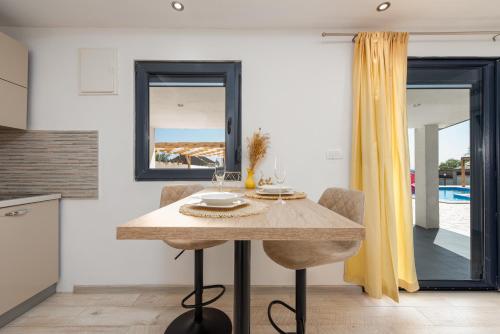 a dining room with a table with two chairs at Unique Villa V with large pool in Benkovac