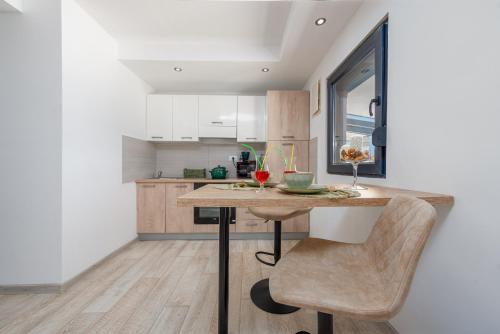 a kitchen with a table and a chair in a room at Unique Villa V with large pool in Benkovac