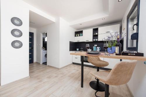 a kitchen with a table and chairs in a room at Unique Villa V with large pool in Benkovac