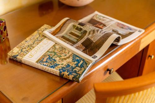 two books sitting on top of a table at Hotel & Residence Venezia 2000 in Venice-Lido