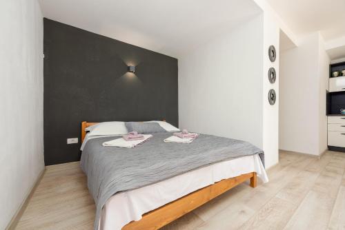 a bedroom with a large bed with a black headboard at Unique Villa V with large pool in Benkovac