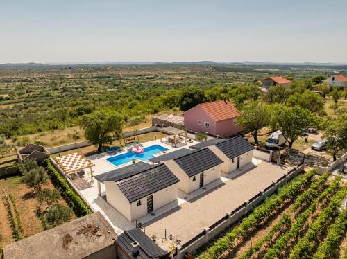 an aerial view of a house with a swimming pool at Unique Villa V with large pool in Benkovac