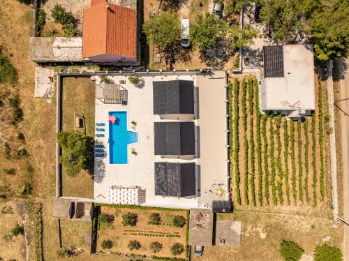 an overhead view of a white house with solar panels at Unique Villa V with large pool in Benkovac