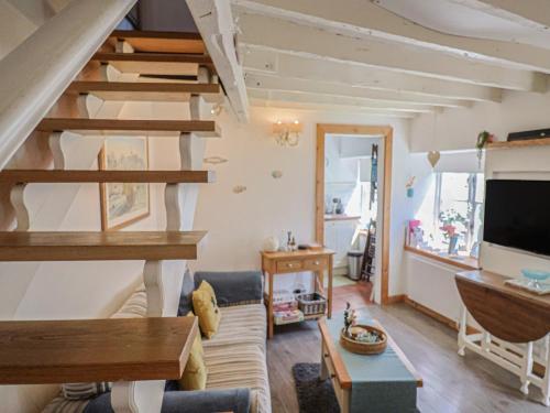 a living room with a couch and a tv at Cleve Cottage in Lyme Regis