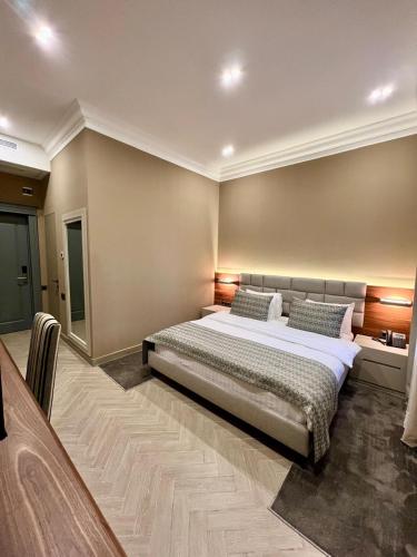 a bedroom with a large bed in a room at Plaza Viktoria Hotel Yerevan in Yerevan