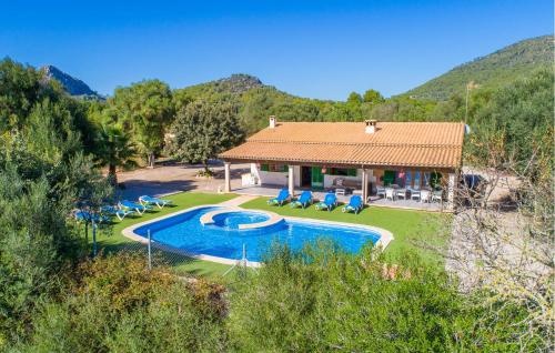 a villa with a swimming pool in front of a house at Sa Sargantana in Llucmajor