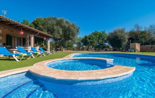 a swimming pool in a yard with chairs and a house at Sa Sargantana in Llucmajor