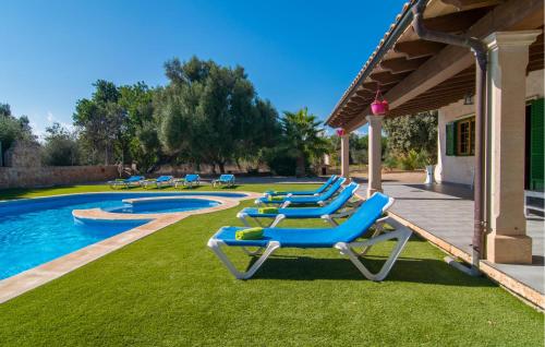 a row of lounge chairs next to a swimming pool at Sa Sargantana in Llucmajor