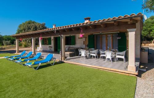 a deck with chairs and a table and a grill at Sa Sargantana in Llucmajor