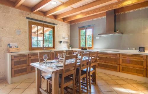 a large kitchen with a wooden table and chairs at Sa Sargantana in Llucmajor