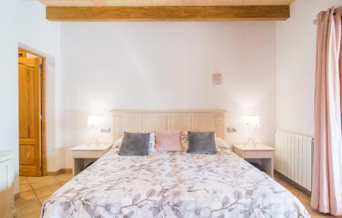 a bedroom with a large bed with two tables at Sa Sargantana in Llucmajor