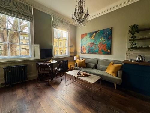 a living room with a couch and a table at Bijou Beauty - Bath Abbey in Bath