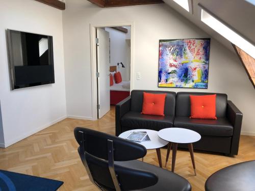a living room with a couch and a table at Best Western Plus Hotel Eyde in Herning