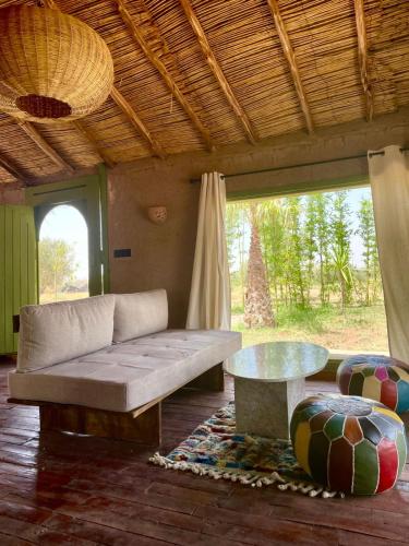 a living room with a couch and a table at Hotel & Spa La Ferme El Dar in Marrakech