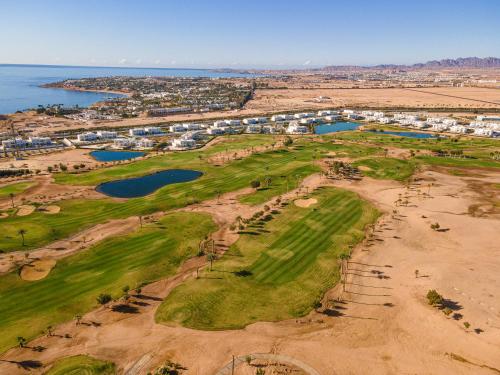 an aerial view of a golf course on the beach at Pickalbatros Golf Luxury Suites - All Inclusive in Sharm El Sheikh