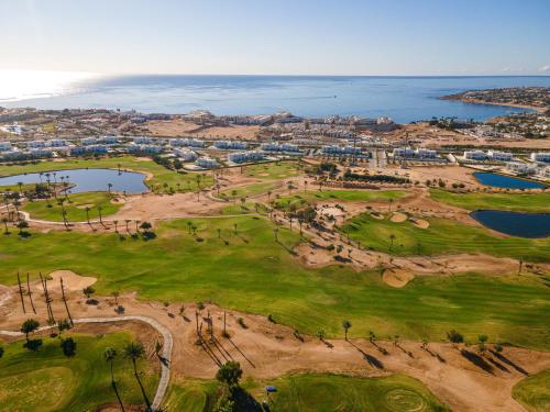 an aerial view of a golf course next to the ocean at Pickalbatros Golf Luxury Suites - All Inclusive in Sharm El Sheikh