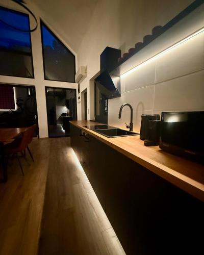 a kitchen with a sink and a counter at Mátramélye Vendégház in Parád