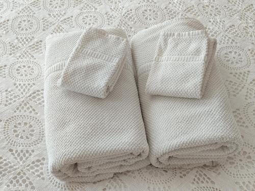 two white towels sitting on top of a bed at Villa Marie in Courçon
