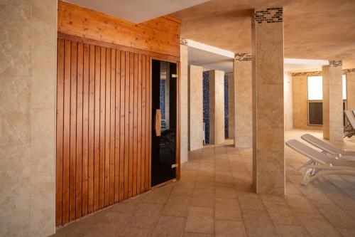a hallway of a house with a wooden door at Apartamentos Azul Playa in Cala d´Or