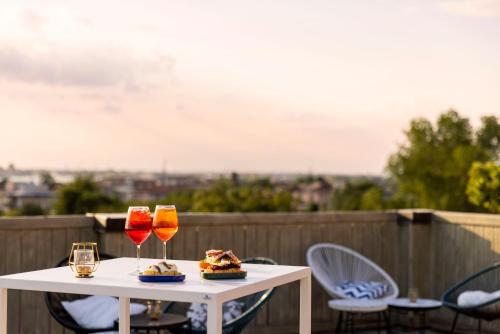 a table with two glasses of wine on a balcony at Hotel & Residence Venezia 2000 in Venice-Lido