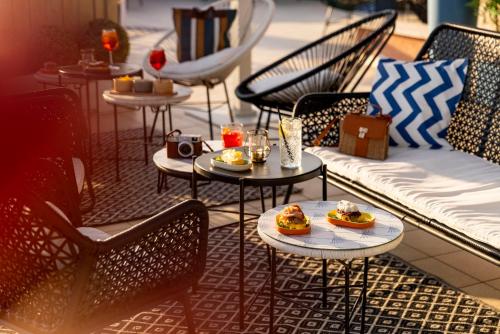 a patio with tables and chairs with food on them at Hotel & Residence Venezia 2000 in Venice-Lido