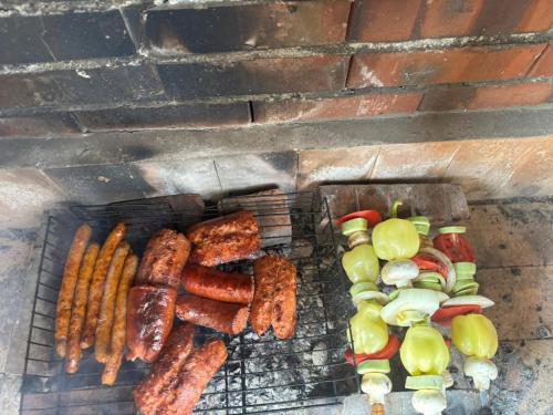 a grill with sausages and vegetables on it at MEDINA in Sarajevo