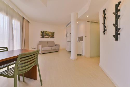 a living room with a table and a couch at Apartamentos Azul Playa in Cala d´Or