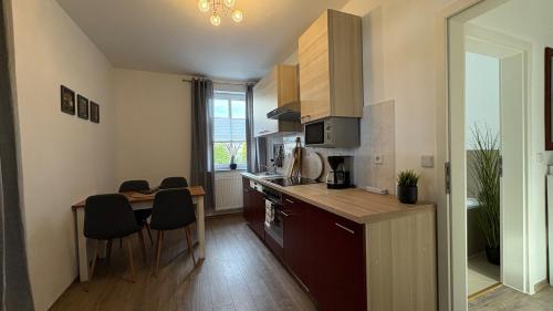 a kitchen with a table and a counter top at Haus am Röblinsee - Ferienwohnungen in Fürstenberg in Fürstenberg-Havel