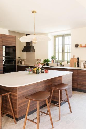 a kitchen with a large island with two stools at Mas de l'Etoile in Aureille