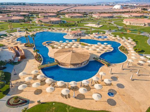 an aerial view of a resort swimming pool with umbrellas at Pickalbatros Golf Luxury Suites - All Inclusive in Sharm El Sheikh
