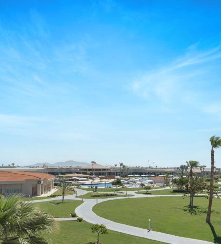 a park with palm trees and a road at Pickalbatros Golf Luxury Suites - All Inclusive in Sharm El Sheikh