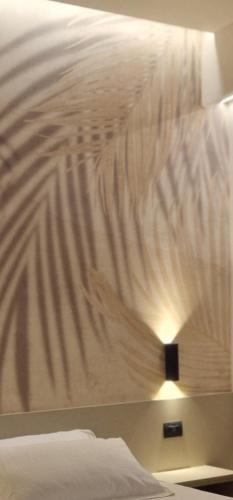 a bedroom with a bed and a wooden wall at Hotel La Rocca in San Marino