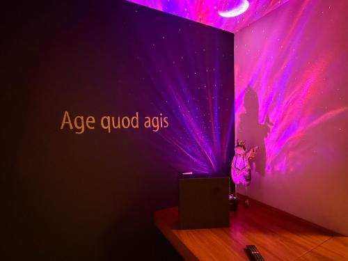 a woman standing in a room with a purple wall at Hotel Krone Sihlbrugg in Sihlbrugg Dorf