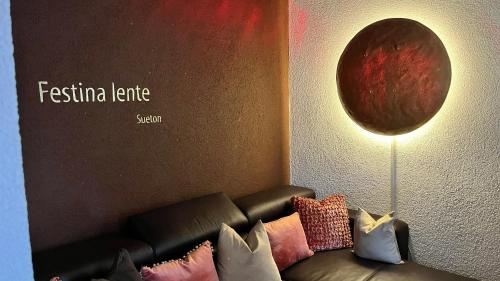 a living room with a couch and a painting on the wall at Hotel Krone Sihlbrugg in Sihlbrugg Dorf